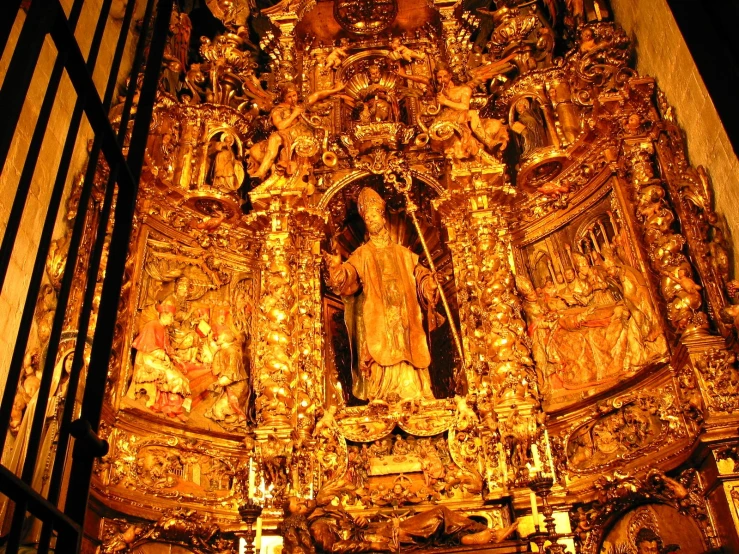 a religious sculpture made out of gold colored material