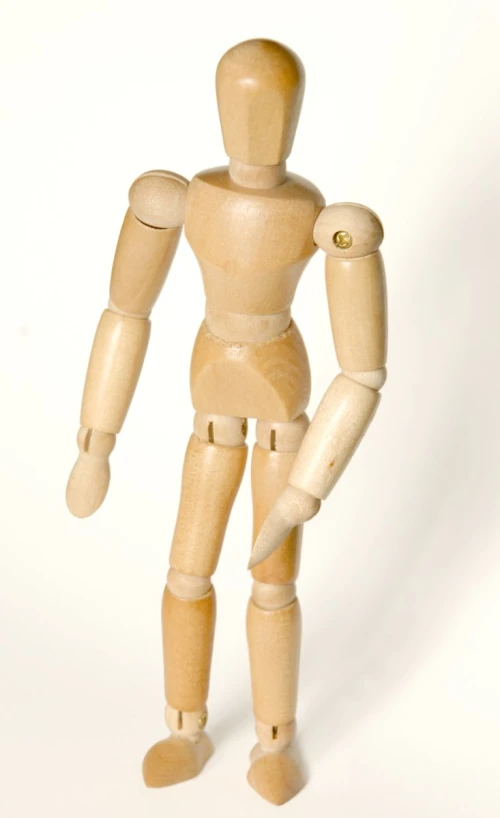 a wooden model of a person with its legs crossed