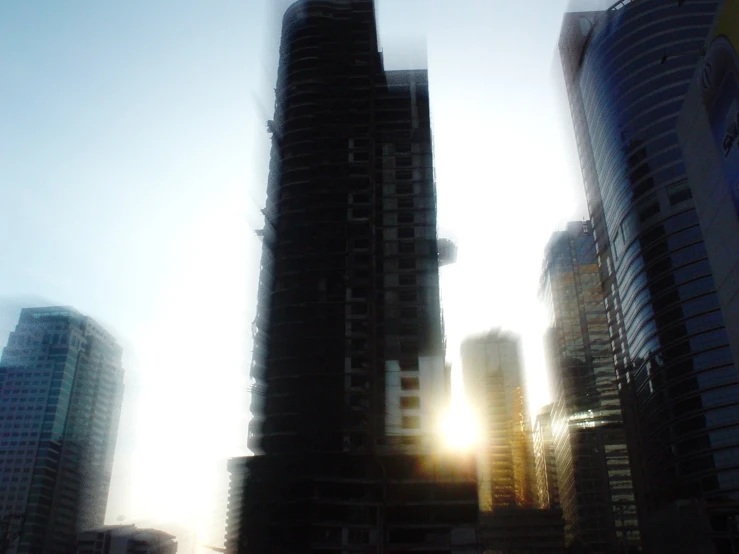 the setting sun in a city, seen from the water