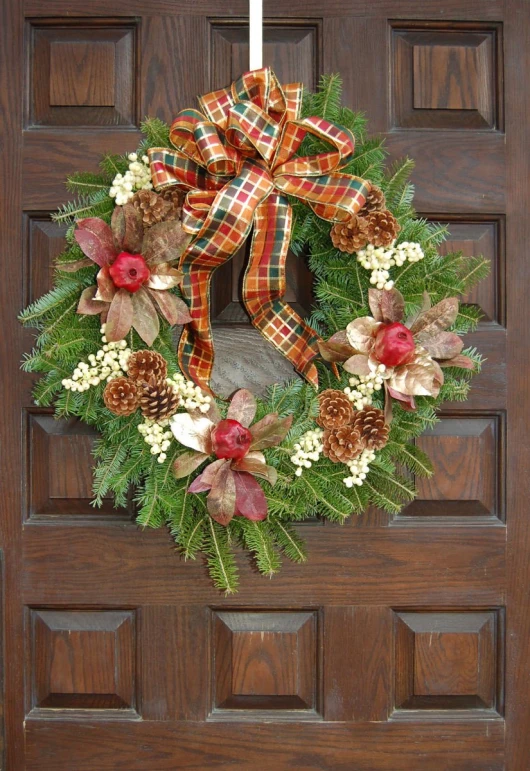 a wreath is hanging on a brown door