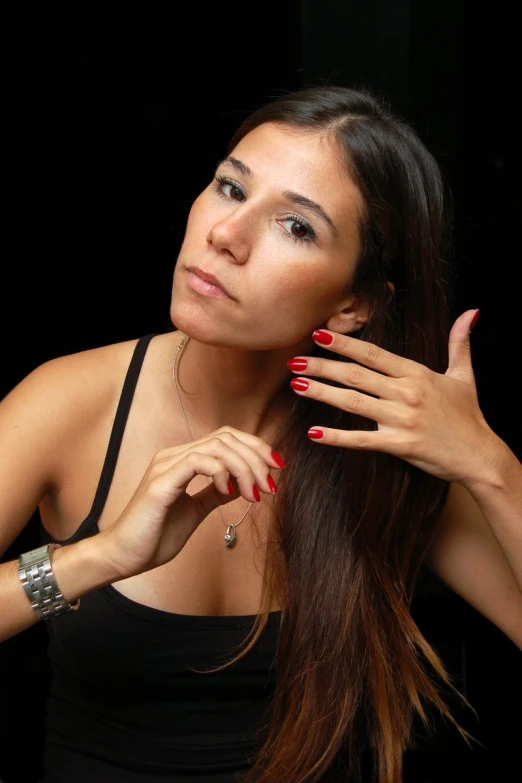 the woman has a red manicure and celet