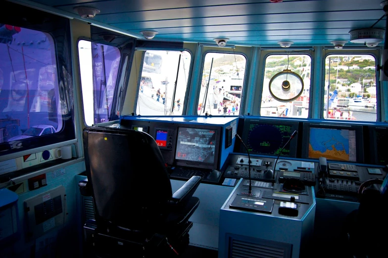 a room with several windows and electronic equipment on the counter