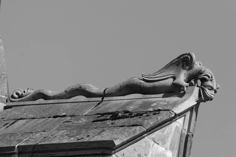 an old building with a gargoyle on the front roof