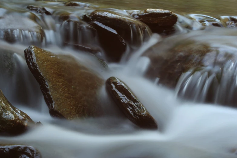 a creek flowing down a river covered in rocks