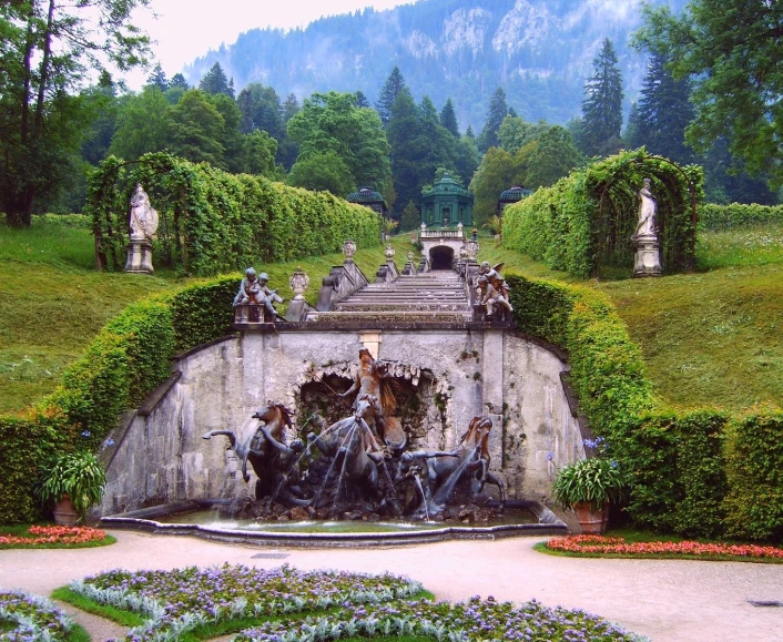 the gardens have beautiful designs of sculptures and greenery on display