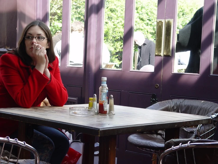 a woman sitting at a table in a restaurant