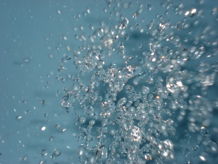 water with droplets of bubbles in blue water
