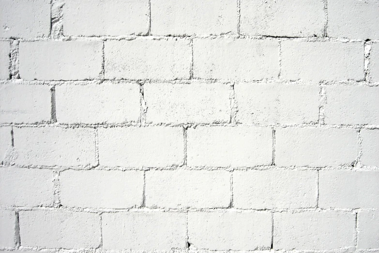 a black and white brick wall with cement mortar blocks