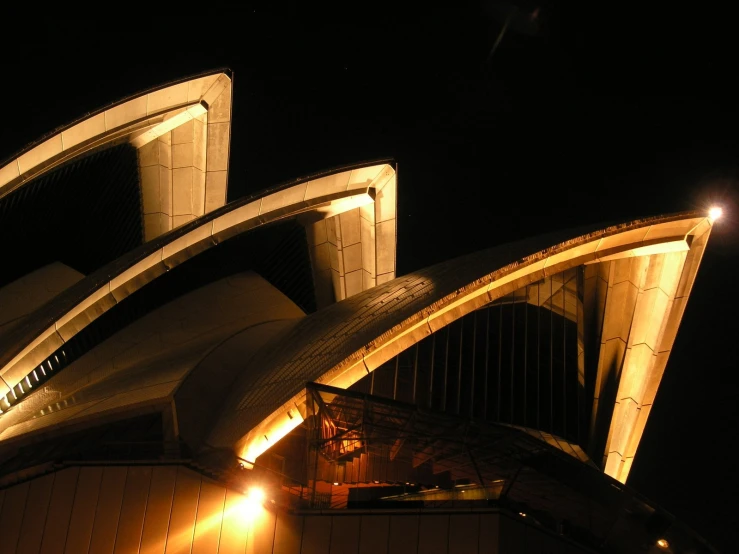 the top part of a building with lights at night