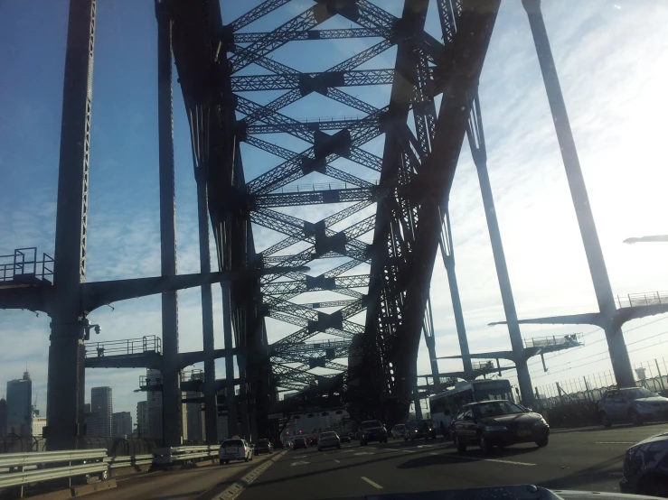 some cars are driving over a bridge in traffic