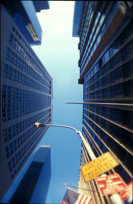 a view down a street at a street lamp, with a lot of buildings behind