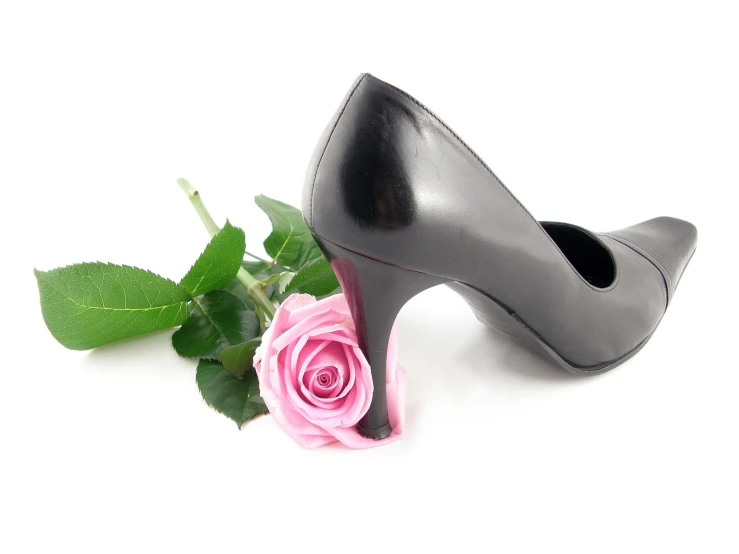 a pair of black high heeled shoes with pink flowers