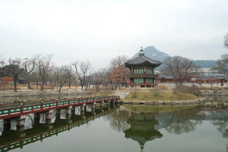 an old bridge sits above a small pond