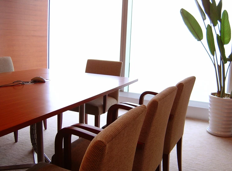 an empty conference room with a long table and chairs