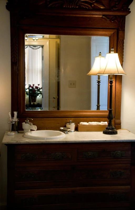 a large bathroom vanity with a lamps and large mirror