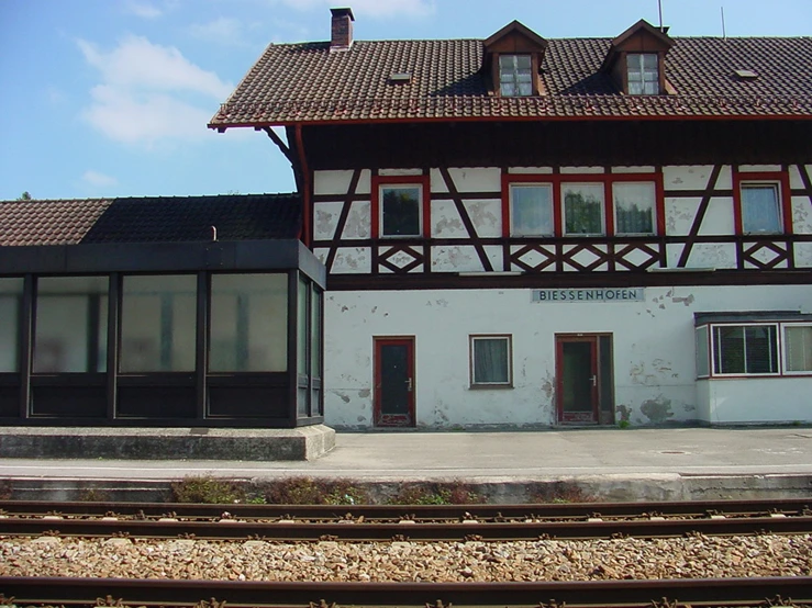 an older style train station with the outside of a house
