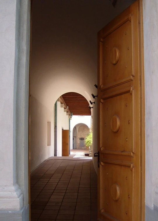 an open door in a hallway leading to a building