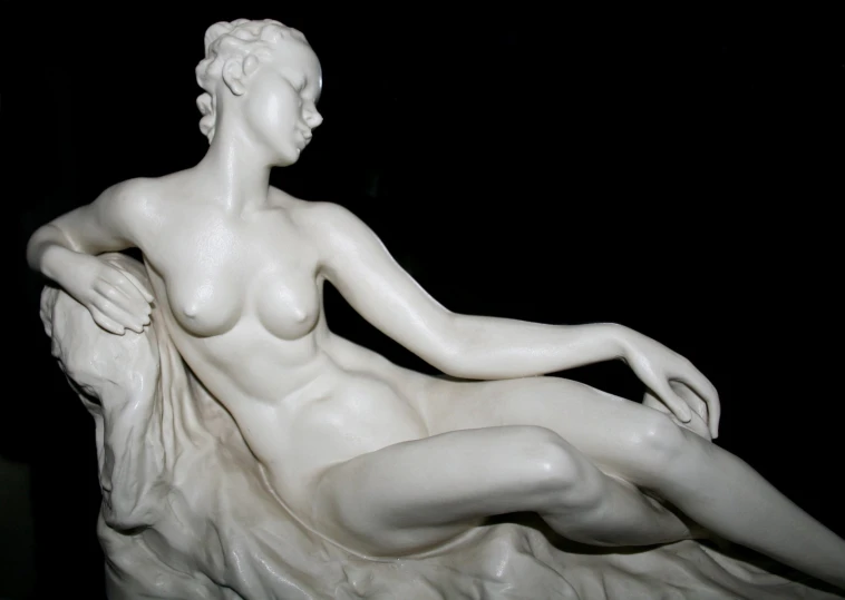 a statue that is white with a  female on it