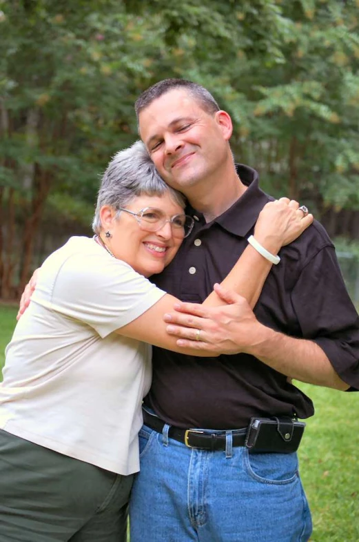 two people that are standing in the grass