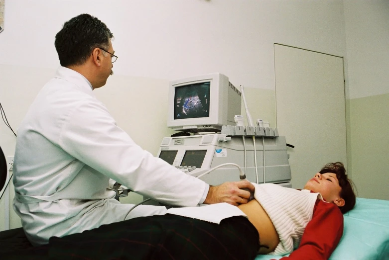 the nurse is looking at a woman in a bed