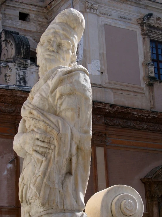 a statue of a man with a hat and jacket