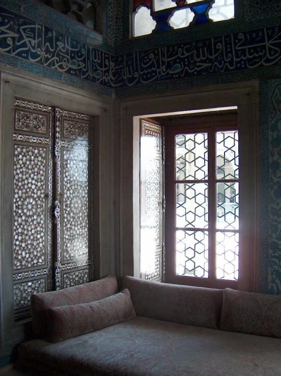 an elaborately decorated window with a single couch