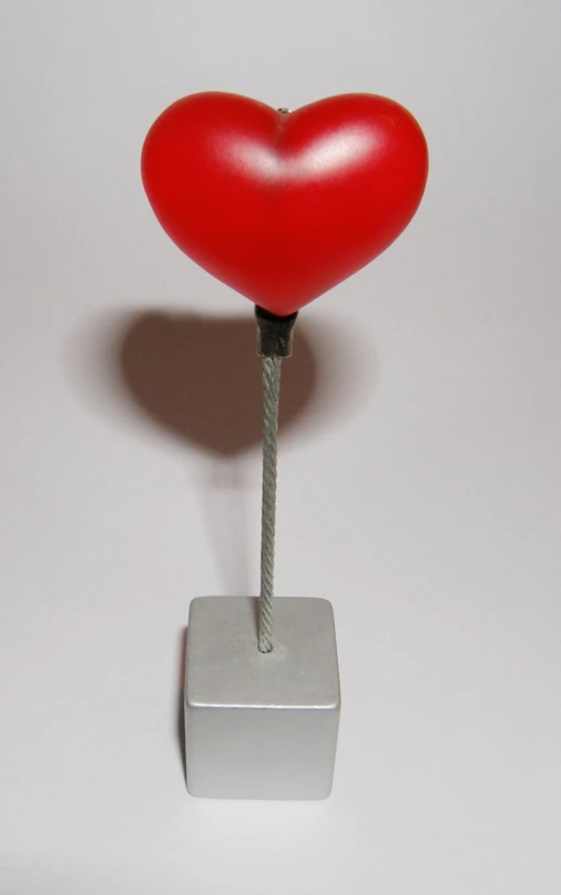 a heart with a metal base and a needle