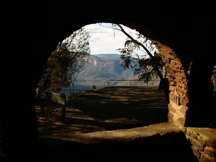 an archway on the side of a mountain