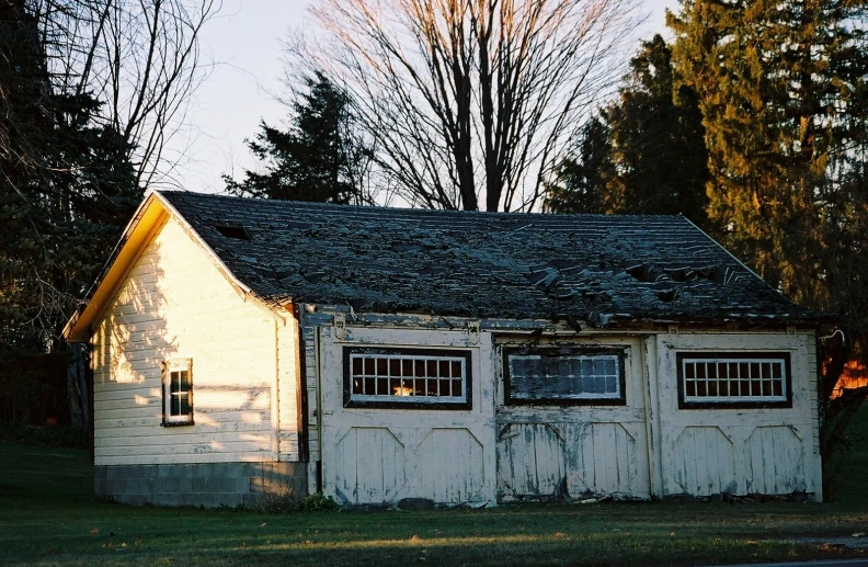 a run down house with some windows and a door