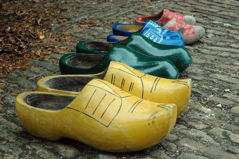 yellow shoes lined up on a cobblestone sidewalk