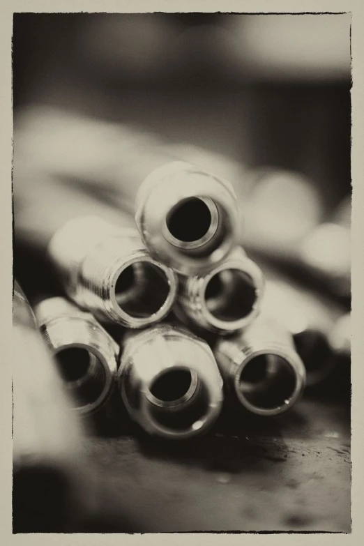 a pile of metal nut tops sitting on top of a table