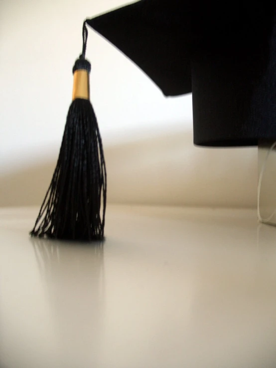 a large black tassel laying across a desk