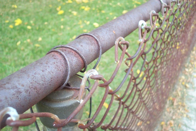 this is an image of a metal fence with lots of rust