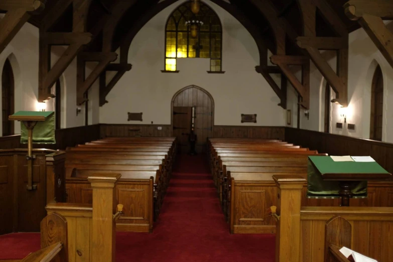the interior of a large church with pews