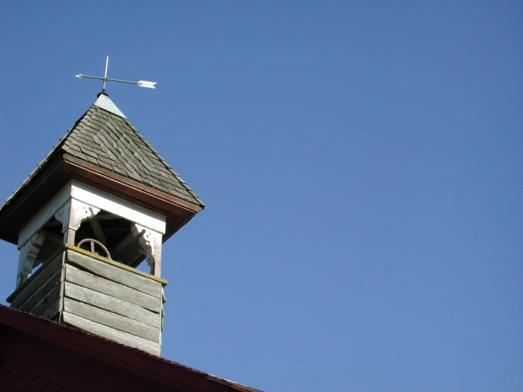 a small tower with a small window and roof on top