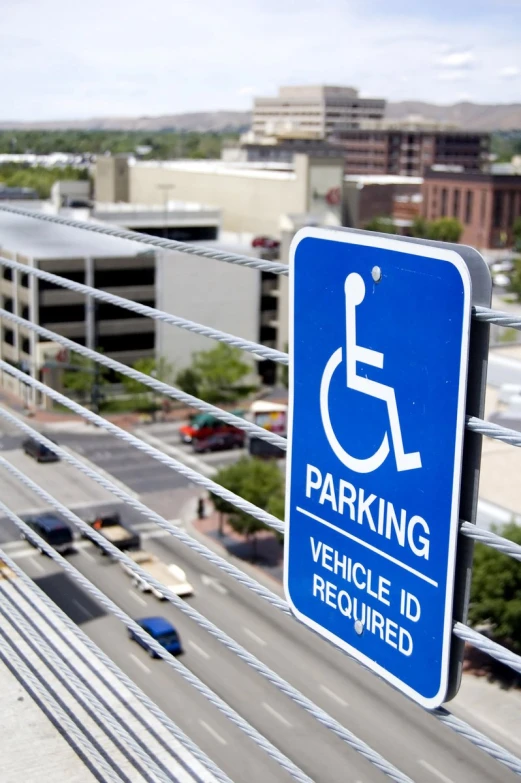 a sign indicates you can park in the parking lot or overpass