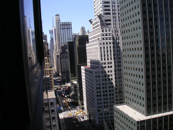 the view from inside a train window showing skyscrs and buildings