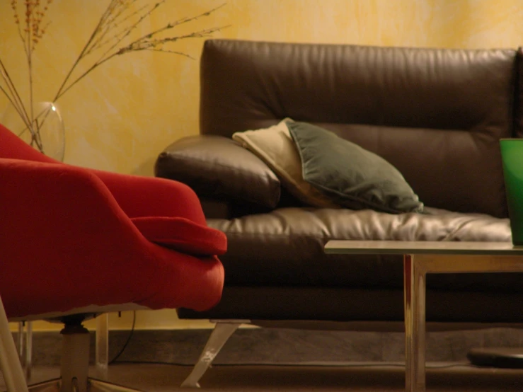 there are two couches with pillows next to a coffee table