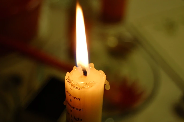 a small candle with some writing on it