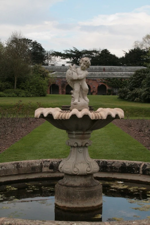 the water fountain has an angel in its arms