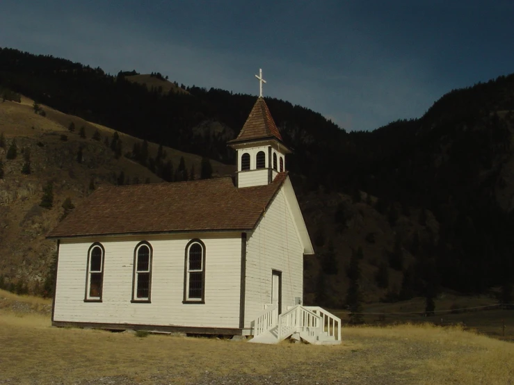 an old church with a steeple in the middle