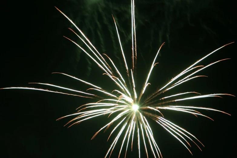 a firework is shown at night, in the background