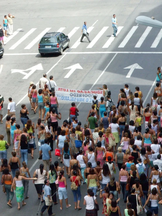 a large group of people that are walking across a street