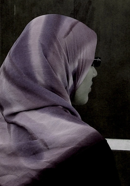 a woman with a long purple cloth around her neck and head