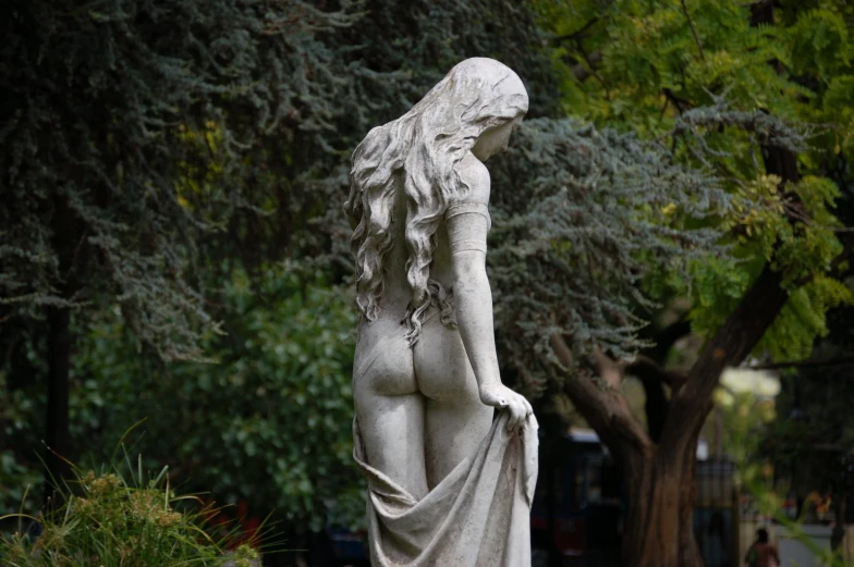 a statue of a woman with long hair and a dress