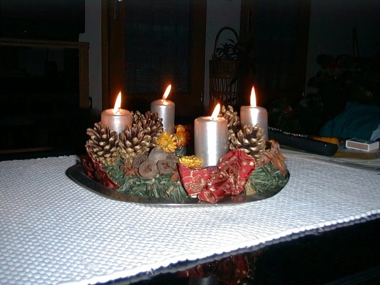 an image of candles with christmas decorations on the table