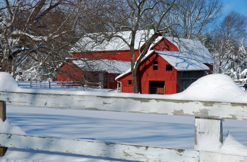 the red barn sits on the side of the farm