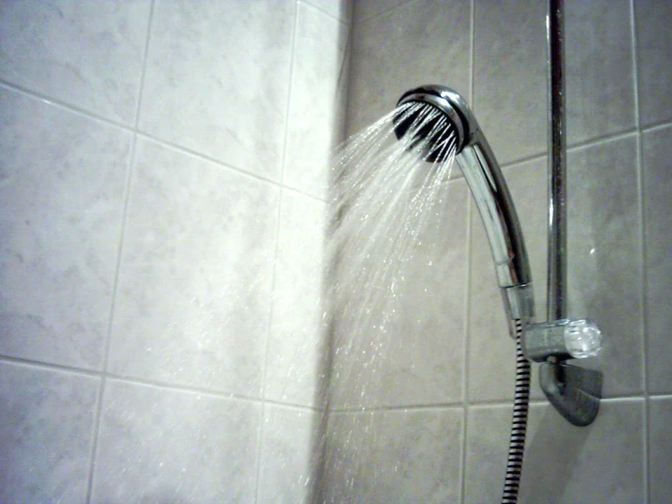 water coming out from the faucet of a shower head