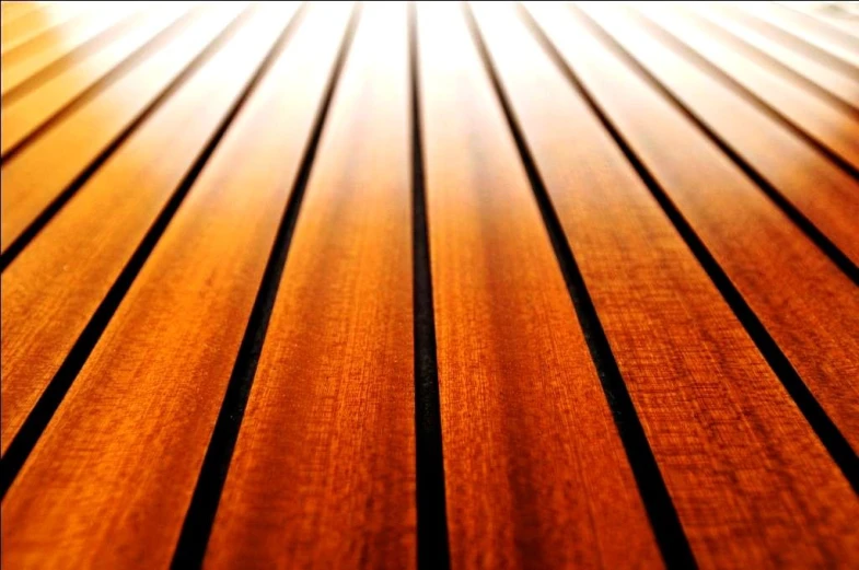 a closeup of wooden slatted boards with sun reflecting off it