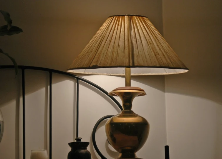 lamp beside decorative objects on wall with dim lighting